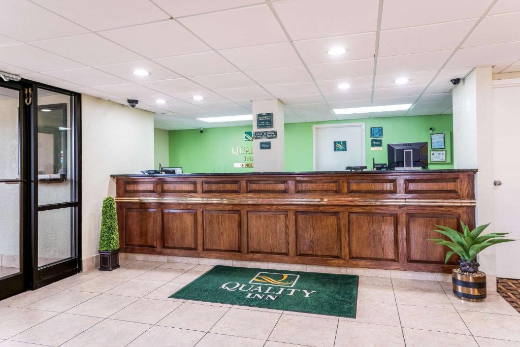 A wooden reception desk with a green carpet with Quality Inn Imprinted on it. This is one of the pet friendly hotels in Rocky Mount.