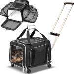 A dog travel carrier with wheels containing two dogs.
