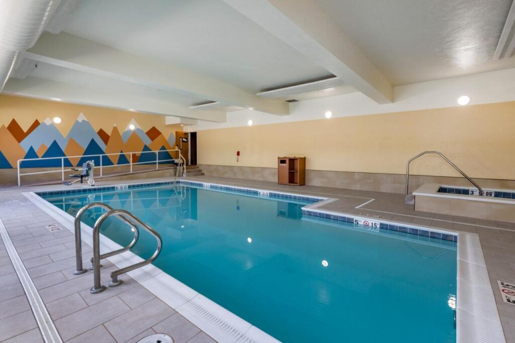 L shaped indoor pool with steel hand rails with a kiddie pool on the side at Comfort Inn a pet freiednly hotel in missoula